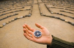 Woman Holding a Compass in a Labyrinth